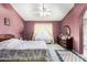Spacious bedroom with a ceiling fan, dresser, and natural lighting at 9014 E Sharon Dr, Scottsdale, AZ 85260