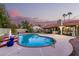Backyard pool with a patio and seating for entertaining, complete with a covered dining area at 9014 E Sharon Dr, Scottsdale, AZ 85260
