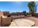 Spacious backyard features a built-in grill, hardscape patio, and wrought iron fence at 911 E Lovegrass Dr, San Tan Valley, AZ 85143