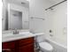 Bathroom features a toilet, sink, vanity, mirror, and a shower-tub combination at 911 E Lovegrass Dr, San Tan Valley, AZ 85143
