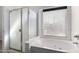 Bathroom featuring a soaking tub, separate shower, and bright natural light offers a relaxing and spa-like feel at 911 E Lovegrass Dr, San Tan Valley, AZ 85143