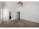 Spacious bedroom with ceiling fan, carpet, and access to the bathroom and closet creates a relaxing retreat at 911 E Lovegrass Dr, San Tan Valley, AZ 85143