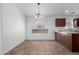 Cozy dining area featuring tile floors, a chandelier, and access to the kitchen at 911 E Lovegrass Dr, San Tan Valley, AZ 85143