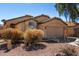 Attractive one-story home with a tile roof and a two-car garage with desert landscaping at 911 E Lovegrass Dr, San Tan Valley, AZ 85143