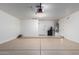 Spacious garage with a sealed floor, water heater, and garage door opener at 911 E Lovegrass Dr, San Tan Valley, AZ 85143