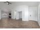 Bright, open-concept living area with tile flooring, vaulted ceilings, and abundant natural light at 911 E Lovegrass Dr, San Tan Valley, AZ 85143