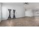 Open living space boasts tile floors, a ceiling fan, and access to the backyard at 911 E Lovegrass Dr, San Tan Valley, AZ 85143