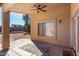 Covered patio with ceiling fan, patterned rug, and outdoor access at 911 E Lovegrass Dr, San Tan Valley, AZ 85143