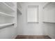 Organized walk-in closet with shelves and hanging rods, maximizing storage space for an efficient lifestyle at 911 E Lovegrass Dr, San Tan Valley, AZ 85143