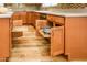 Kitchen cabinets feature pull-out shelves for easy storage, and complement the wood-look flooring at 9833 E Crystal Dr, Sun Lakes, AZ 85248