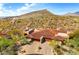 Desert home boasts a tile roof, attached garage, and desert landscaping amid a mountainous backdrop at 9904 E Lookout Mountain Dr, Scottsdale, AZ 85262