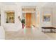 Bright foyer boasts travertine floors, a wood door with sidelights, and a decorative niche for artwork at 9904 E Lookout Mountain Dr, Scottsdale, AZ 85262