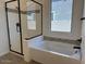 Bathroom featuring a shower, soaking tub, and patterned tile at 10027 W Verde Ln, Avondale, AZ 85392