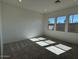 Bedroom featuring neutral carpet, painted walls, and bright windows at 10027 W Verde Ln, Avondale, AZ 85392