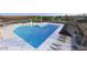 Resort-style community pool with sun loungers and splash pad for hours of relaxation and fun at 10027 W Verde Ln, Avondale, AZ 85392