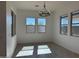 Dining room featuring painted walls, gray tile flooring, and bright windows at 10027 W Verde Ln, Avondale, AZ 85392