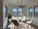 Dining room with a modern chandelier and a table set for a meal at 10027 W Verde Ln, Avondale, AZ 85392