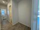 Hallway with tile floor leading to bathroom and kitchen at 10027 W Verde Ln, Avondale, AZ 85392