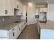 Bright kitchen with white cabinetry, granite countertops, and stainless steel appliances at 10027 W Verde Ln, Avondale, AZ 85392