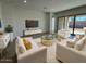 Well-lit living room featuring stylish sofas, decorative pillows, and designer coffee table at 10027 W Verde Ln, Avondale, AZ 85392