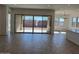 Bright living room featuring tile flooring, large windows, and an open floor plan at 10027 W Verde Ln, Avondale, AZ 85392