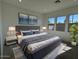 Main bedroom featuring a large bed, bedside tables, and bright windows at 10027 W Verde Ln, Avondale, AZ 85392