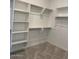 Walk-in closet featuring white shelving and carpeted flooring at 10027 W Verde Ln, Avondale, AZ 85392