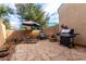 This backyard with stone floors and a patio set perfect for grilling and outdoor seating at 1015 S Val Vista Dr # 81, Mesa, AZ 85204
