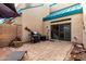 A cozy backyard with a stone patio, perfect for entertaining with a grill and seating area at 1015 S Val Vista Dr # 81, Mesa, AZ 85204