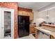 Kitchen featuring wooden cabinets, a black refrigerator, and bright floral wallpaper at 1015 S Val Vista Dr # 81, Mesa, AZ 85204