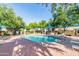 Resort-style community pool featuring ample seating, mature trees and clear blue water at 1015 S Val Vista Dr # 81, Mesa, AZ 85204