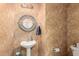 Charming powder room featuring unique textured walls, decorative mirror, and pedestal sink at 1015 S Val Vista Dr # 81, Mesa, AZ 85204