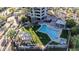 Aerial view of a resort-style pool area, luxurious apartment building, and outdoor seating at 1040 E Osborn Rd # 404, Phoenix, AZ 85014