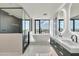 Bright bathroom with double vanity, soaking tub, and glass enclosed shower at 1040 E Osborn Rd # 404, Phoenix, AZ 85014