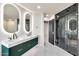Bright bathroom featuring a double vanity, illuminated mirrors, and a glass shower at 1040 E Osborn Rd # 404, Phoenix, AZ 85014