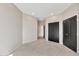 Spacious bedroom featuring black closet doors and neutral color palette at 1040 E Osborn Rd # 404, Phoenix, AZ 85014