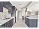 Elegant kitchen with shaker cabinets, white backsplash and countertops, and stainless steel appliances at 1040 E Osborn Rd # 404, Phoenix, AZ 85014