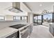 Modern Kitchen with stainless appliances, a breakfast bar, and city views at 1040 E Osborn Rd # 404, Phoenix, AZ 85014