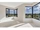 This bright living space features corner windows with unobstructed views of the green golf course landscape at 1040 E Osborn Rd # 404, Phoenix, AZ 85014