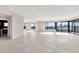 Expansive living room features sleek tile flooring, recessed lighting, and large windows with city views at 1040 E Osborn Rd # 404, Phoenix, AZ 85014