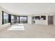 Spacious open floor plan featuring tile flooring, expansive windows, and a convenient kitchen bar area at 1040 E Osborn Rd # 404, Phoenix, AZ 85014