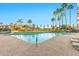 Resort-style pool with palm trees and covered lounging areas in a well-maintained community at 1040 E Osborn Rd # 404, Phoenix, AZ 85014