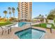 Luxury building with spa and pool area, complemented by palm trees and well-kept landscaping at 1040 E Osborn Rd # 404, Phoenix, AZ 85014