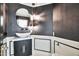 Stylish powder room with unique lighting, a vessel sink, and sleek black and white decor at 1040 E Osborn Rd # 404, Phoenix, AZ 85014