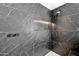 Close-up of marble shower featuring a shower niche and modern fixtures at 1040 E Osborn Rd # 404, Phoenix, AZ 85014