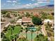 Aerial view of a desert property featuring a private backyard oasis with a pool, tennis court, and desert landscaping at 10541 E Windrose Dr, Scottsdale, AZ 85259