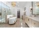 Spa-like bathroom with a freestanding tub, double vanity, and walk-in shower at 10541 E Windrose Dr, Scottsdale, AZ 85259