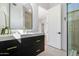 Elegant bathroom with marble countertop, dark wood cabinets, brass hardware, and glass-enclosed shower at 10541 E Windrose Dr, Scottsdale, AZ 85259