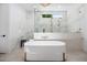 Luxurious bathroom featuring a soaking tub, a walk-in shower with dual shower heads, and marble accents at 10541 E Windrose Dr, Scottsdale, AZ 85259