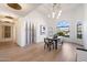 Elegant dining room featuring a modern chandelier, wine storage, and large windows at 10541 E Windrose Dr, Scottsdale, AZ 85259